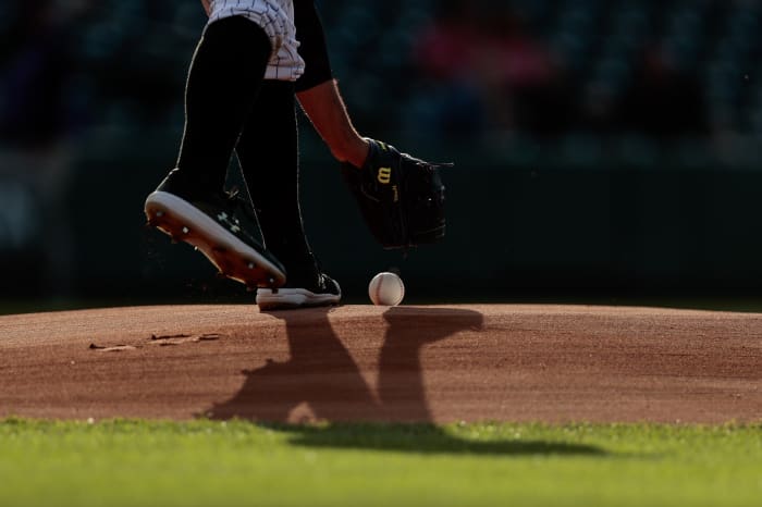 Jun 2, 2021; Denver, Colorado, USA; Colorado Rockies starting pitcher Antonio Senzatela (49) picks up the game ball from the mound before the game against the Texas Rangers at Coors Field.